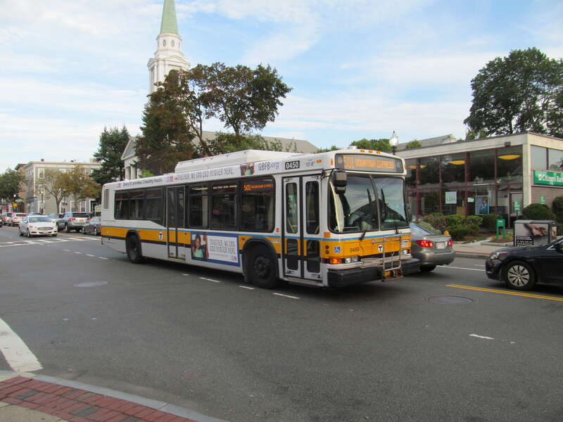 An MBTA bus on route 501 in Brighton Center in August 2016. The bus will head west to Newton Corner, where it will enter the Massachusetts Turnpike to go east to Downtown Boston.