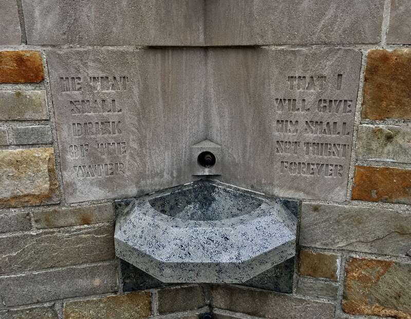 As seen in December 2020: adorning a holy water font at the National Shrine of the Little Flower in Royal Oak, Michigan, is a relief carving of a thematically appropriate passage from the Gospel of John: &quot;he that shall drink of the water that I will