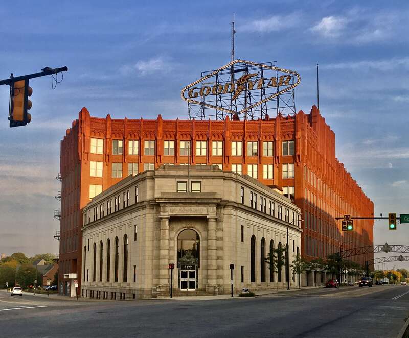 This September 2020 view of the southeast corner of East Market Street and Goodyear Boulevard, in the East End of Akron, Ohio, comprises the former Ohio Savings and Trust Company building in the foreground and Goodyear Hall behind it. Both built in