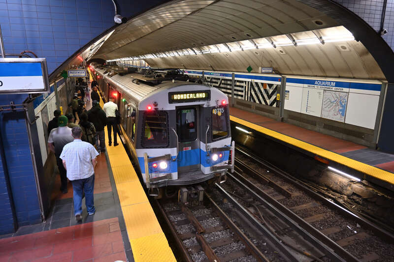 Passengers board an outbound Blue Line train at Aquarium