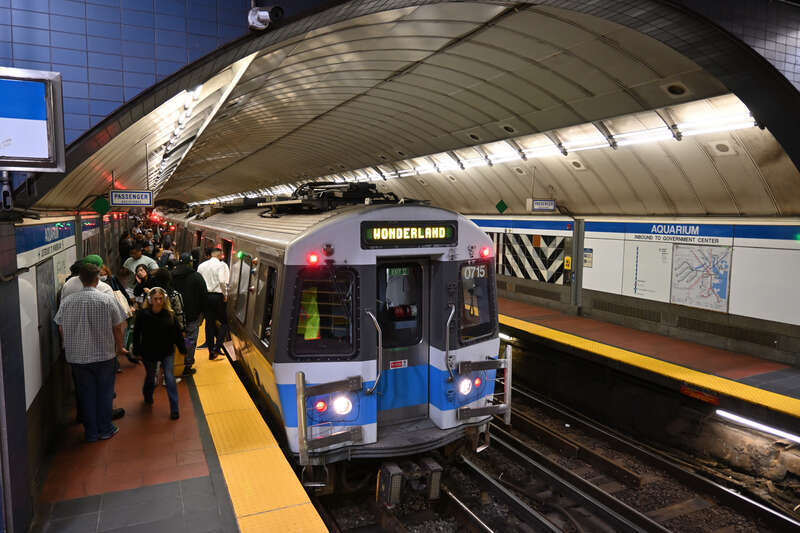 Passengers board an outbound Blue Line train at Aquarium