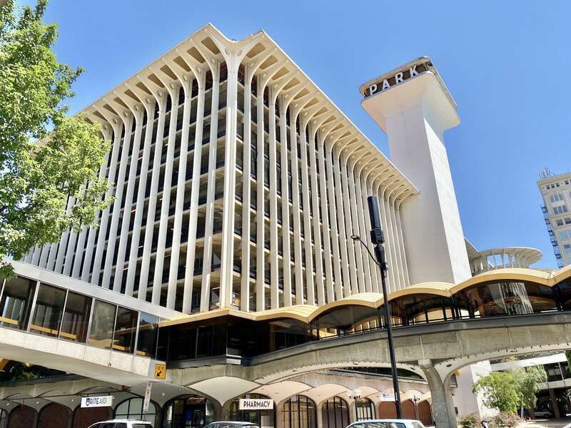 Built in 1967, this Brutalist building was designed by Warren C. Heylman to serve as a parking garage, known as Parkade Plaza.  The building features a concrete structure, exterior fins with flared brackets at the cornice, vaulted ceilings below the