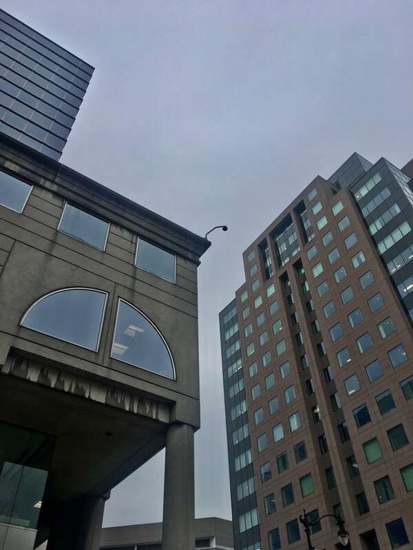 Towering paragons of postmodern architecture as seen from the corner of Main and East Chippewa Streets, Buffalo, New York, January 2020: the M&amp;amp;T Center (left) and 50 Fountain Plaza (right).