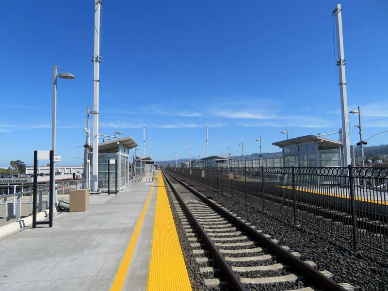 Northbound platform at San Bruno station in June 2018. Several catenary poles are visible.