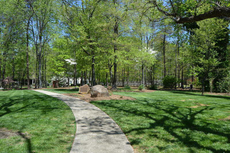 A lawn in the Tanger Bicentennial Gardens, located off Cornwallis Drive in Greensboro, North Carolina, United States.  Once occupied by an early Presbyterian seminary (commemorated by the plaques on the large stones at the center of the picture, the