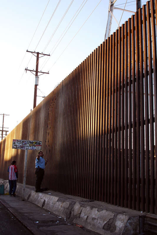 Lizbeth took this photo
A couple of guys showed up,
with a welded re-bar home-made ladder, to climb this umclimbable new fence. The home-made re-bar ladder was hooked up at the top of the fence simply by bending the top re-bar into a hook, and