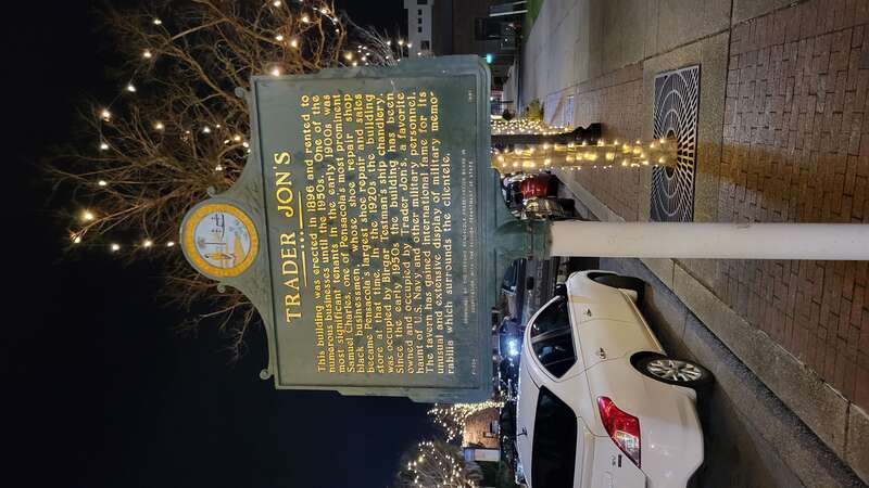 A historical marker in front of the former Trader Jon's, erected in 1991