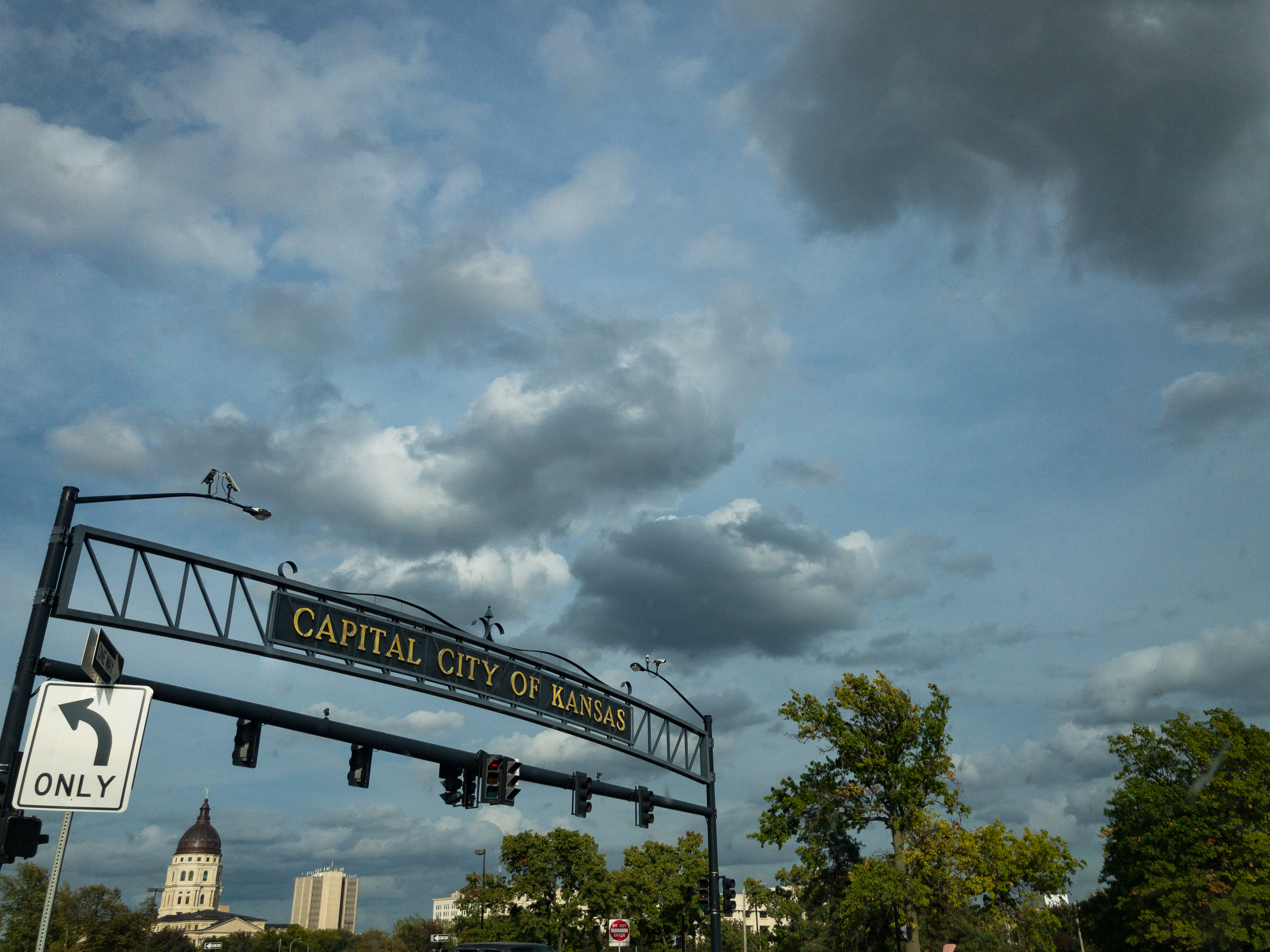 Signage in Topeka, Kansas reads "Capital City of Kansas" with surveillance cameras on it.