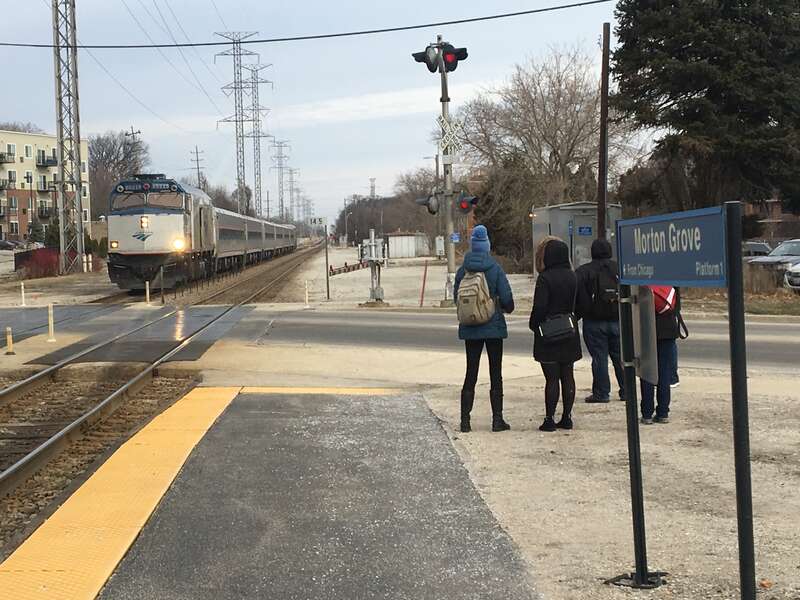 An Amtrak train approaches the Morton Grove Metra station.