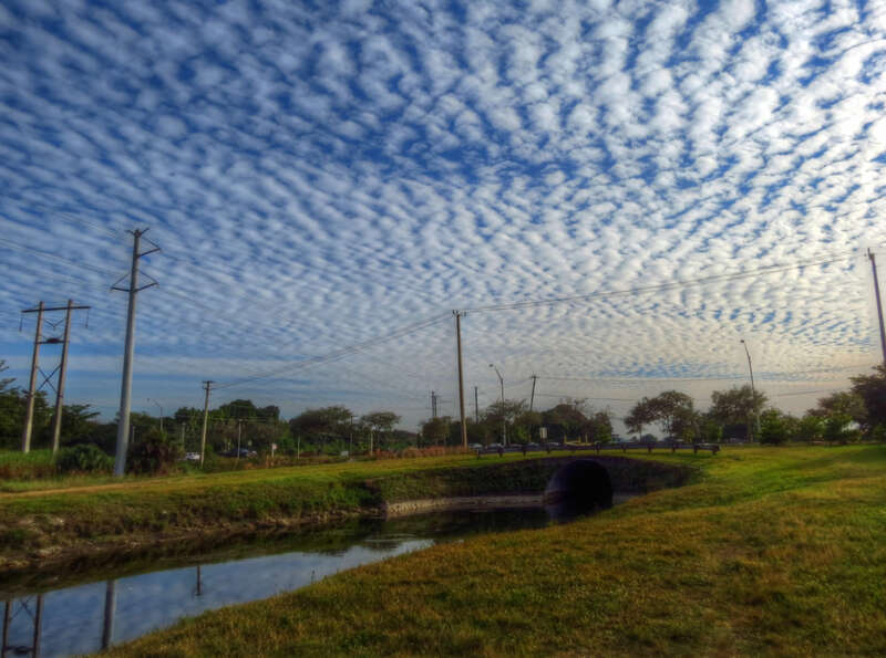 500px provided description: Canal in Miami, Florida with clouds in early morning. [#Water ,#Sky ,#Clouds ,#Miami ,#Canal ,#Canal in Miami]