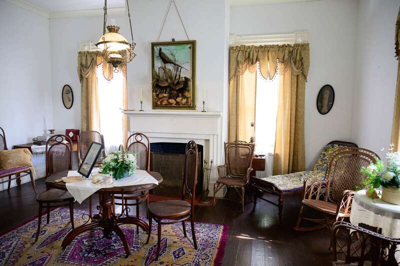 Photograph of the interior of the Bronson-Mulholland House standing in the upstairs bentwood parlor.