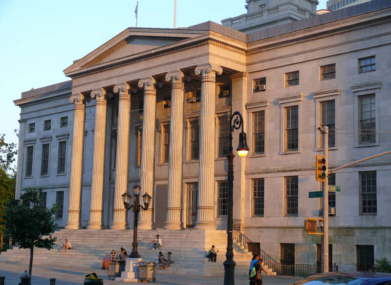 Brooklyn Borough Hall was designed in 1835 by architect Gamaliel King, and constructed under the supervision of superintendent Stephen Haynes. It was completed in 1849 to be used as the City Hall of the City of Brooklyn.