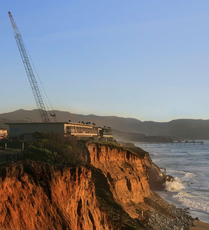 On December 17, 2009 30 feet chunk of the cliff below the apartment building fell to Pacific Ocean. Residents were given 20 minutes to evacuate the building. Now the workers are trying to save it.
