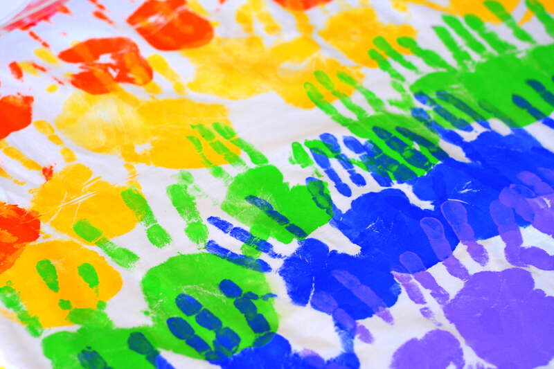 A tablecloth at church imprinted with the hands of the Sunday School kids.