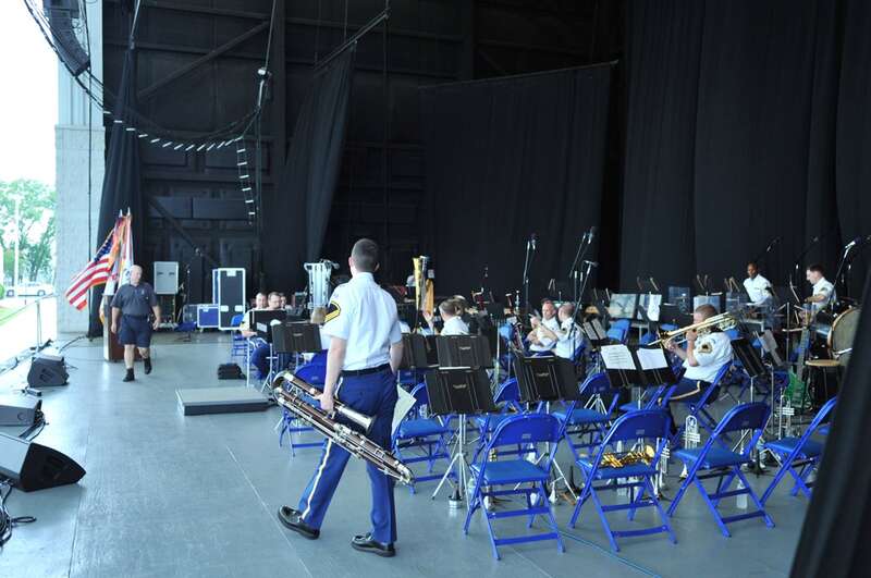 The U.S. Army Concert Band, Chorus, and Herald Trumpets recently performed at the 2010 Virginia Arts Festival.  Here, SSG Dean Woods takes his seat in the bassoon section while SFC Marcus Truelove completes the stage set up for the performance.