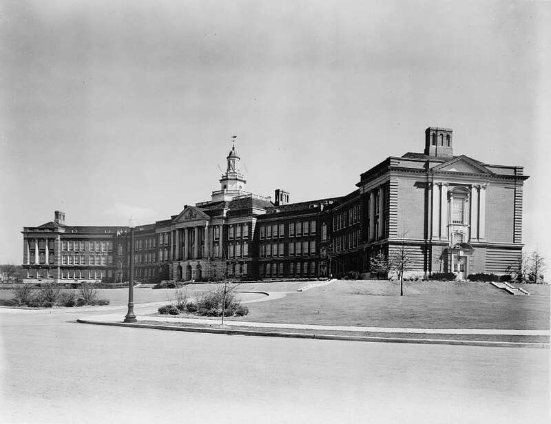 Photograph shows exterior view of the Pierre S. Dupont High School from the street, in Wilmington, Delaware.