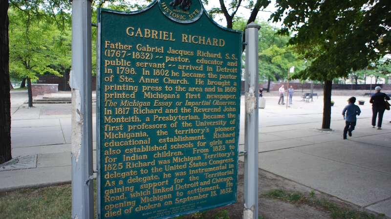 State of Michigan Historical Marker summarizing the life of Fr. Gabriel Richard. Located outside Ste. Anne de Detroit Church.