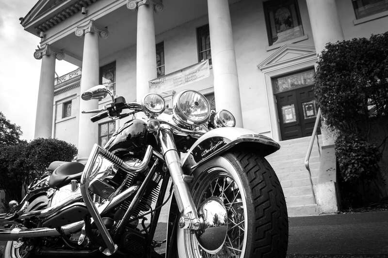 A Harley-Davidson motorcycle parked in front of a the First Christian Church in Eugene, Oregon