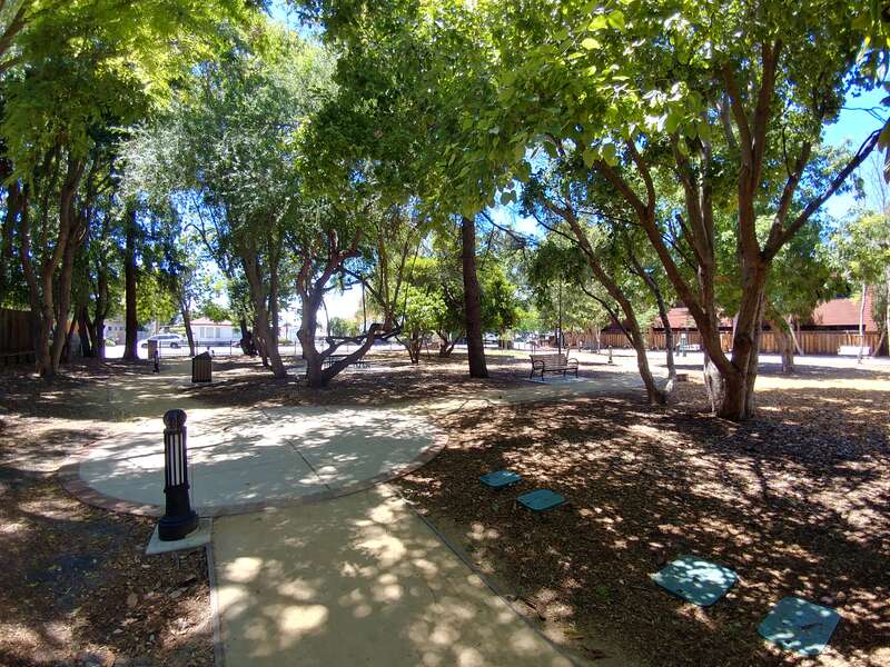 A photograph showing Heritage Park from a point of view within the park boundaries towards Rengstorff Avenue (heading: ~270°).