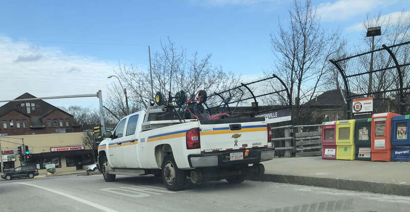 High-railer truck on Walnut Street bridge over the Worcester MBTA commuter rail line and MassPike, next to the Newtonville station entrance.
