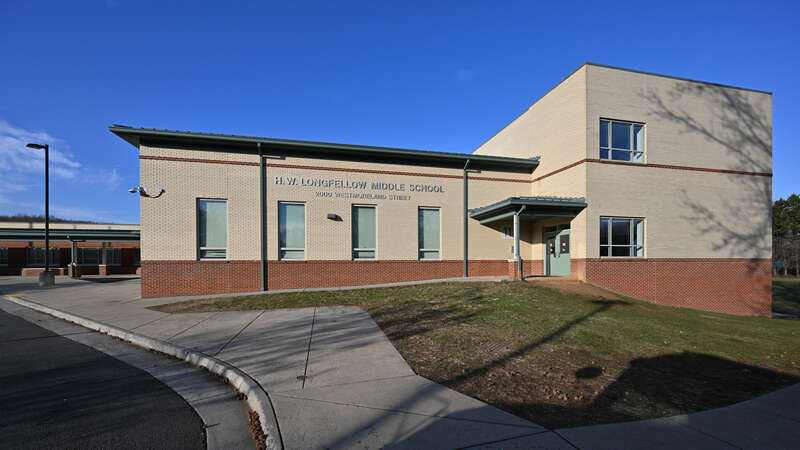 The red and white brick building for Henry Wadsworth Longfellow Middle School, part of Fairfax County Public Schools. 2000 Westmoreland Street, Falls Church, Virginia 22043.