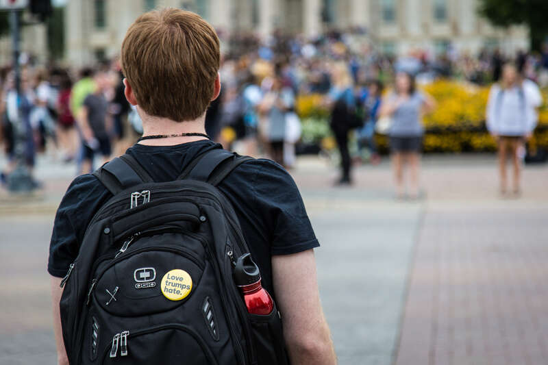 A student waits to cross the street on the first day of a new academic year at the University of Iowa.