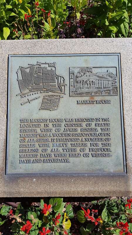 Plaque in the median of the intersection of State and Lodge streets, Albany.  The plaque reads: &quot;The market house was erected in 1704 located in the center of State Street, west of James Street  The market was a wooden structure, open on all sides.