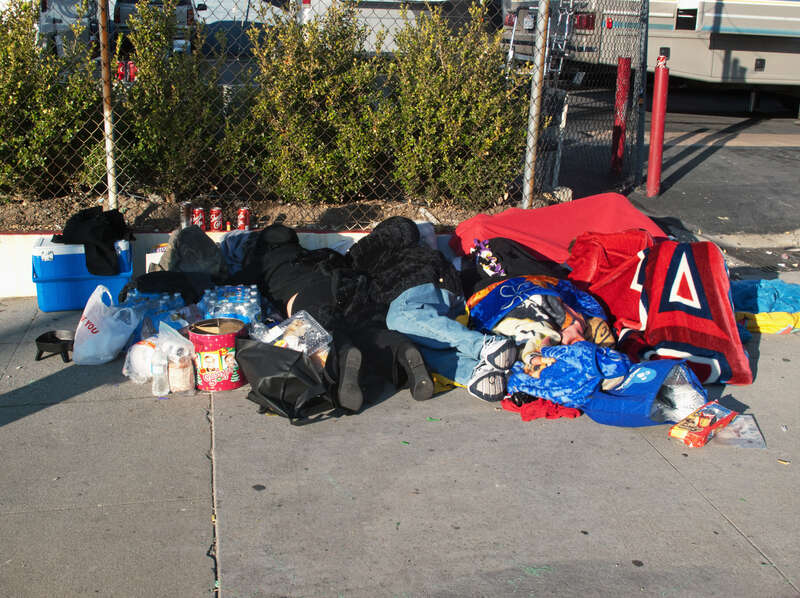 Just off Colorado Boulevard in Pasadena. These people got there early, but must have had a late night - still sleeping at 8:23 a.m., while all around them crowds are anticipating the parade, which will pass through in about 40 minutes.