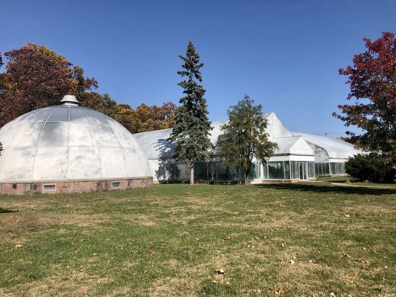 This image depicts the Potawatomi Conservatories at Potawatomi Park in South Bend, Indiana, U.S. The public gardens complex includes the Ella Morris Conservatory and the Muessel-Ellison Conservatory and Desert Dome.