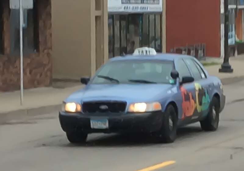 A Ford Crown Victoria taxicab version in service of Rainbow Taxi. This one is the &quot;Fab Cab.&quot; Photographed in St. Paul, Minnesota, United States of America.