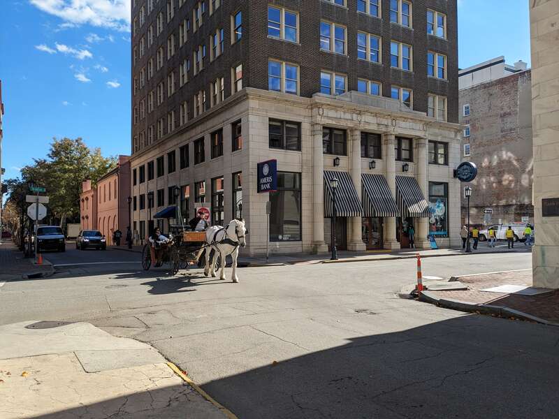 A horse and cart in front of the Ameris Bank/Realty Building at 24 Drayton Street in Savannah, Georgia