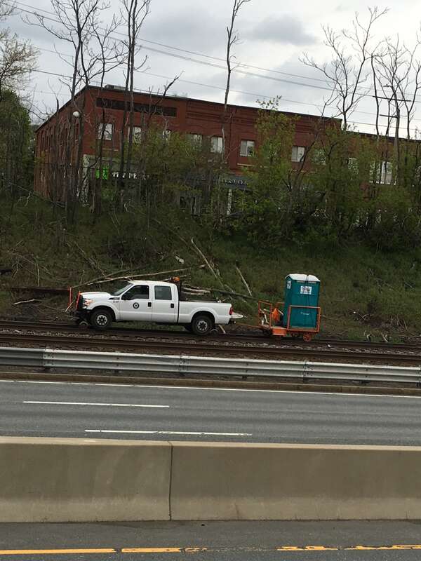 Road-rail vehicle with portable toilet trailer on the MBTA Framingham-Worcester  line in Newtonville, Massachusetts