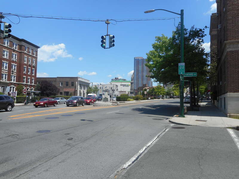 The southwestern end of Huguenot Street at Main Street, where US 1 splits into a one-way pair in New Rochelle, New York.