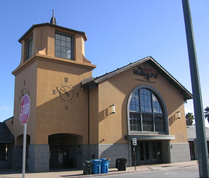 Facade of the San Mateo Caltrain station in downtown San Mateo, California.
With Melting Pot restaurant sign.