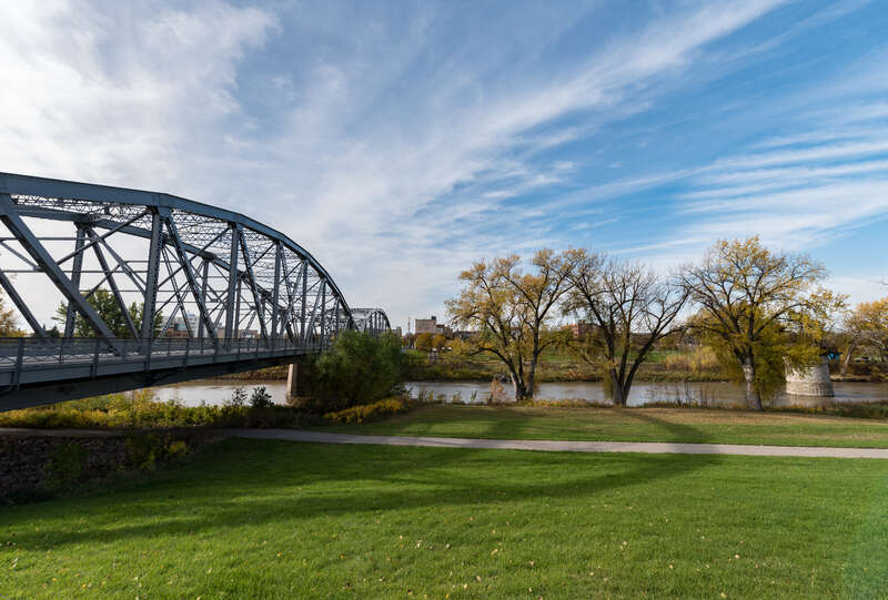 A North Dakota welcome sign on the Sorlie Memorial Bridge over the Red River, connecting East Grand Forks, Minnesota to Grand Forks, North Dakota.