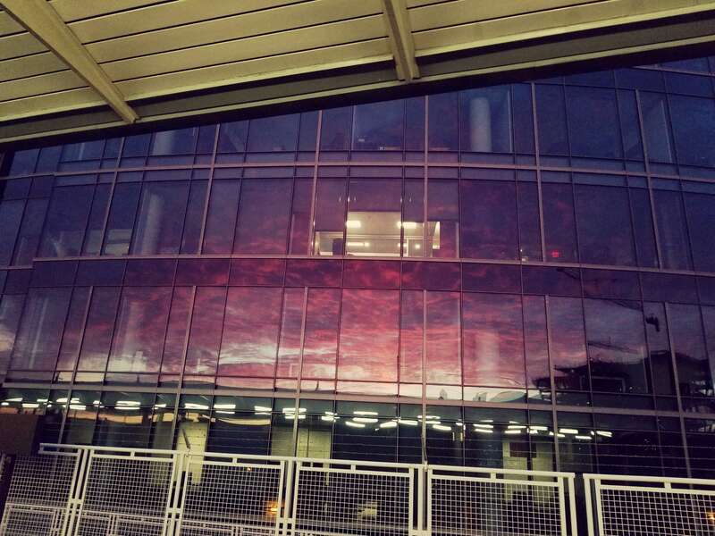 Caught a cool reflection of a vivid sunrise in the windows of a building in NoMa.