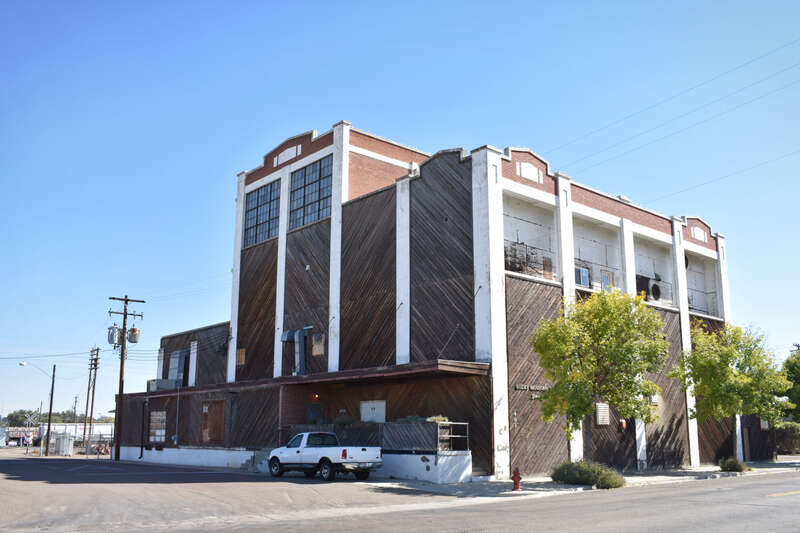 The Swift &amp;amp; Company Building (1926), a 4-story brick building covered in wood.