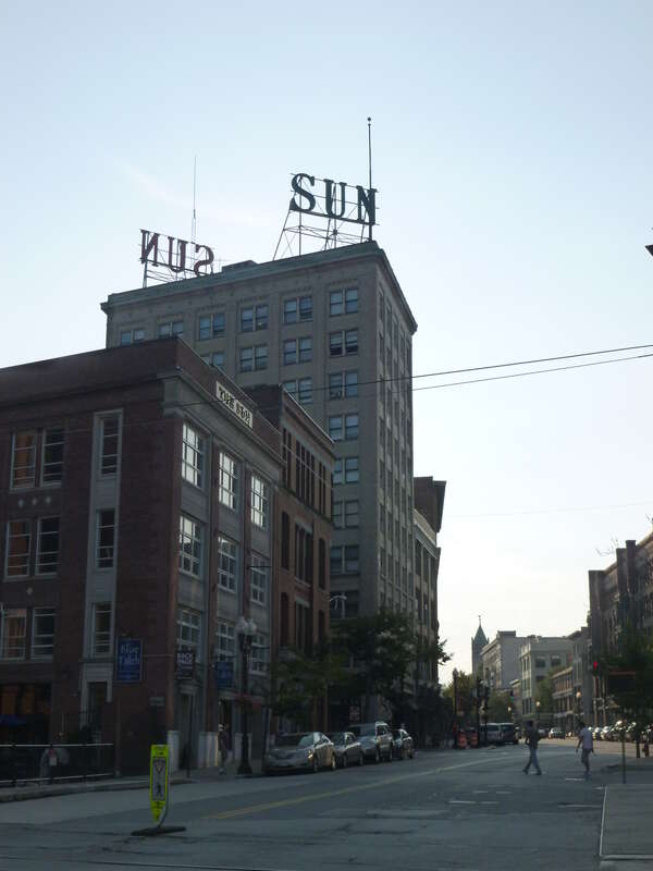 The Lowell Sun building, located at 491 Dutton Street, Lowell, Massachusetts.  East and north sides of building shown, as viewed from the east along East Merrimack Street.