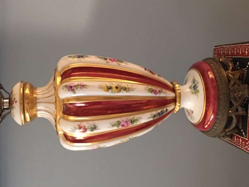 Red and gold vase decorated with floral designs painted by Joseph Simek.