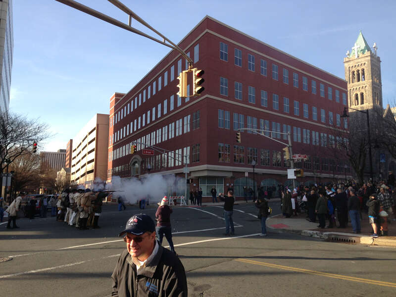 Reenactors exchanging musket fire along South Broad Street (U.S. Route 206 northbound) at Front Street during a reenactment of the Second Battle of Trenton in Trenton, New Jersey
