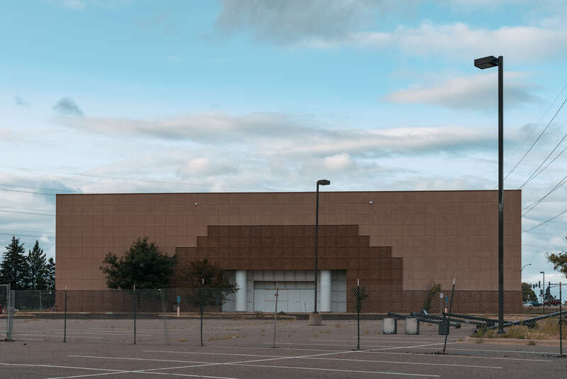 The old, closed Kohl's store in Brooklyn Center, Minnesota, fenced and boarded.