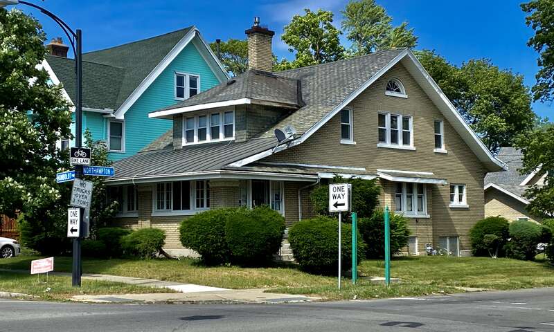 The Anthony Walkowiak House, 1016 Humboldt Parkway at Northampton Street, Buffalo, New York, June 2021. This is a fine representation of a popular design trope in Craftsman-style residential architecture in which a sprawling side-gabled roof - whose