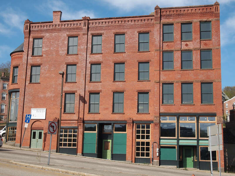Connecticut - New London County - Norwich
National Register of Historic Places #82001007 NRIS
2011 May 01 Water St. view from Chelsea Harbor Dr. view N
edit: none

White sign says "Flatiron Building Restoration". Building is currently empty.