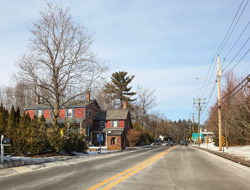 Photo of northbound County Route 73 (Chestnut Ridge Road) in Montvale, New Jersey. Seen in this photo are the Eckerson House (left / west) and the road's crossing of the New York line. Photo taken looking north between Powder Hill Road the state