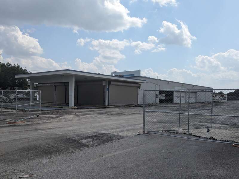 The former Sears Auto Center in Melbourne, Florida surrounded by fencing for demolition work