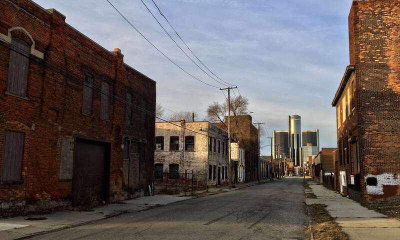 Looking westward along Franklin Street from just past the corner of St. Aubin Street, in one of the few corners of Detroit's Rivertown neighborhood as yet relatively untouched by redevelopment, December 2020. The Renaissance Center rises in the