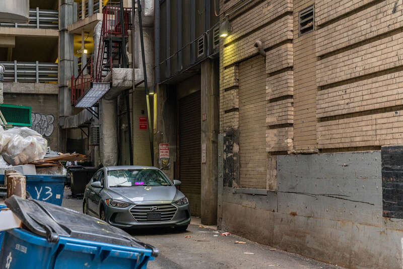 A Lyft driver waits in a car in an alley in downtown Pittsburgh, Pennsylvania.