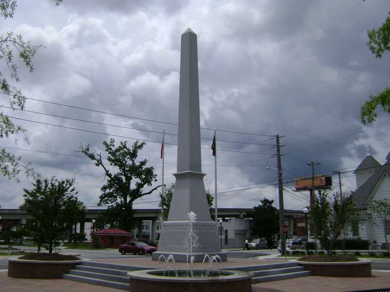 MLK Memorial Park in Valdosta, Lowndes County, Georgia. The James Beck Overpass on Georgia State Route 7 is the elevated roadway. The monument is located in a small plaza at the triangular intersection of E. Martin Luther King, Jr. Drive, S. Ashley
