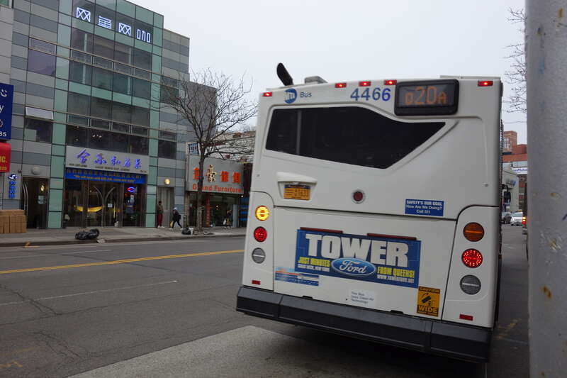 The back of a Orion VII NG bus in Jamaica-bound Q20 service, at Main Street and Northern Boulevard in Downtown Flushing, Queens. Note that this bus has an "MTA Bus" sticker, indicating it has recently been transferred from another depot.