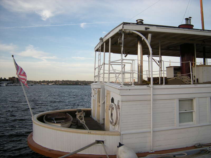 Stern of MV Lotus (with dinghy stashed), normally moored in Olympia, Washington, visiting the Historic Ships Wharf, Seattle, Washington. The 1909 boat is listed on the National Register of Historic Places.